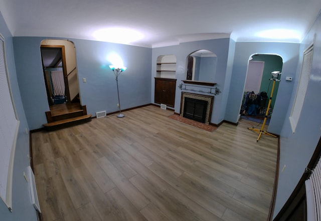 unfurnished living room featuring wood-type flooring