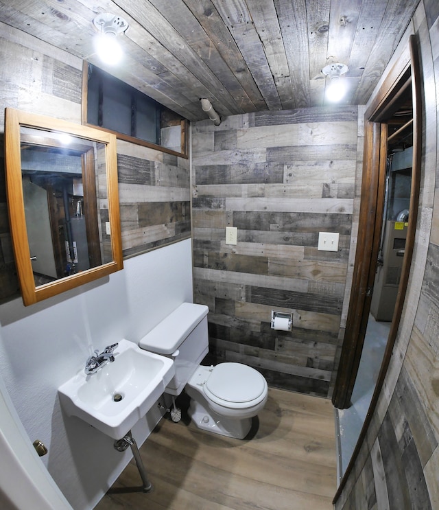 bathroom featuring toilet, wood ceiling, and wood walls