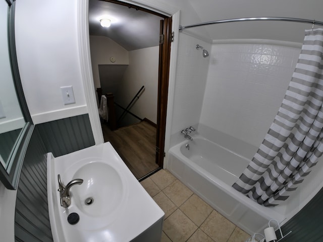 bathroom with tile patterned flooring, vanity, lofted ceiling, and shower / tub combo with curtain