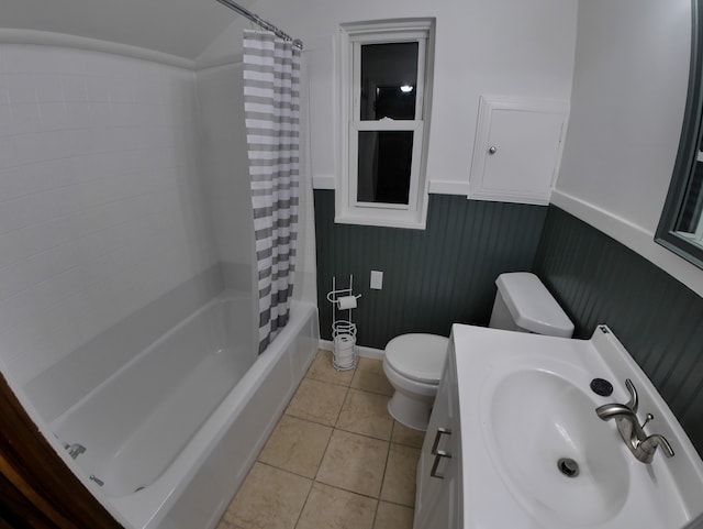 full bathroom featuring tile patterned flooring, vanity, toilet, and shower / bath combo with shower curtain