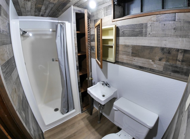 bathroom featuring a shower with curtain, toilet, and hardwood / wood-style flooring