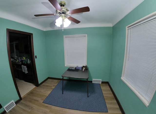 home office featuring hardwood / wood-style flooring and ceiling fan