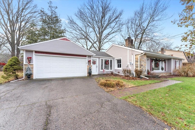 ranch-style house featuring a garage and a front yard