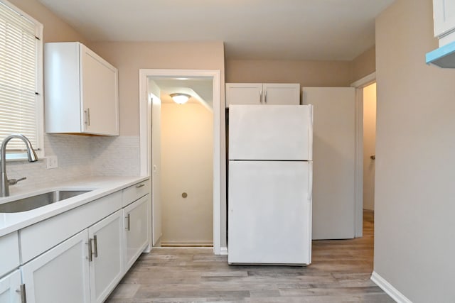 kitchen with sink, white cabinets, and white refrigerator