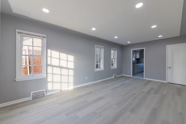 spare room featuring light wood-type flooring