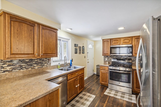 kitchen featuring backsplash, dark hardwood / wood-style flooring, sink, and appliances with stainless steel finishes