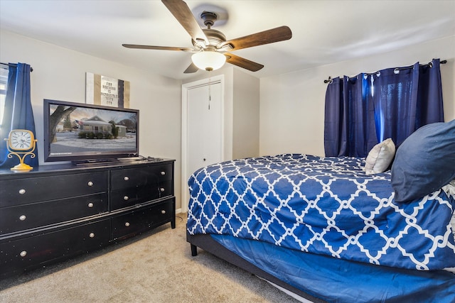 carpeted bedroom featuring ceiling fan and a closet