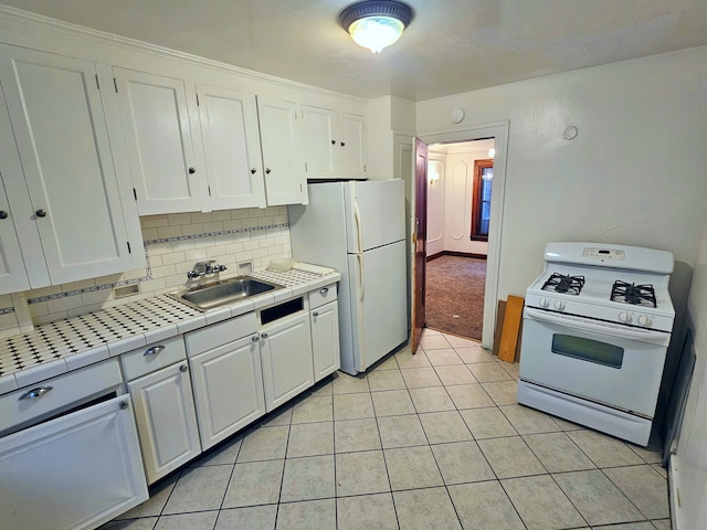 kitchen with white cabinetry, tile counters, sink, backsplash, and white appliances