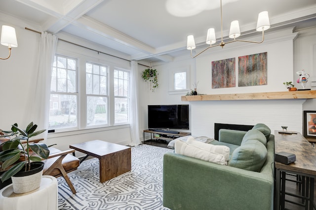 living room with coffered ceiling, crown molding, beam ceiling, a notable chandelier, and a fireplace