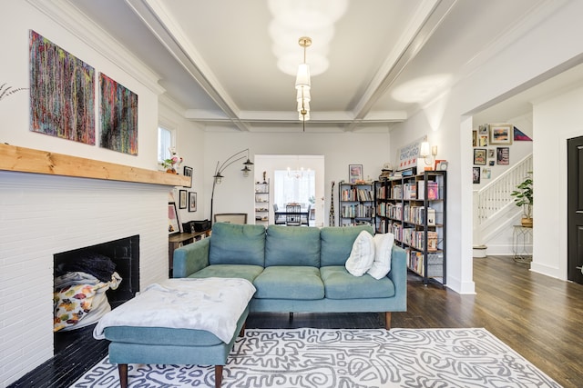 living room featuring beam ceiling, dark hardwood / wood-style floors, an inviting chandelier, and ornamental molding