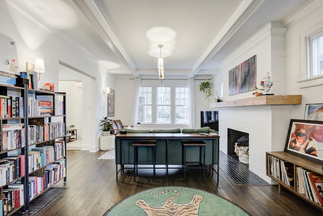 interior space with dark hardwood / wood-style flooring, ornamental molding, a wealth of natural light, and a brick fireplace