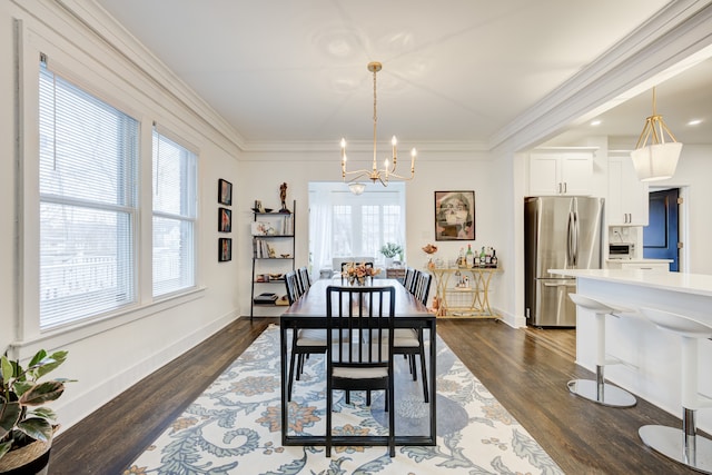 dining area featuring dark hardwood / wood-style floors, ornamental molding, and a chandelier