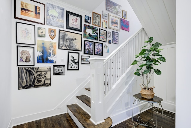 stairs with crown molding and wood-type flooring