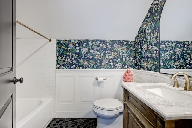 full bathroom featuring washtub / shower combination, vanity, vaulted ceiling, tile patterned flooring, and toilet