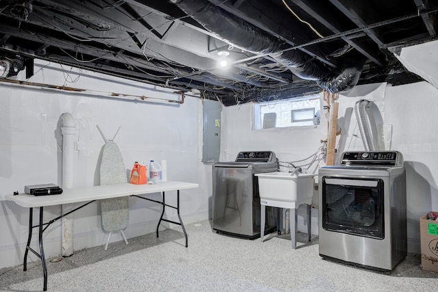 washroom with separate washer and dryer, sink, and electric panel