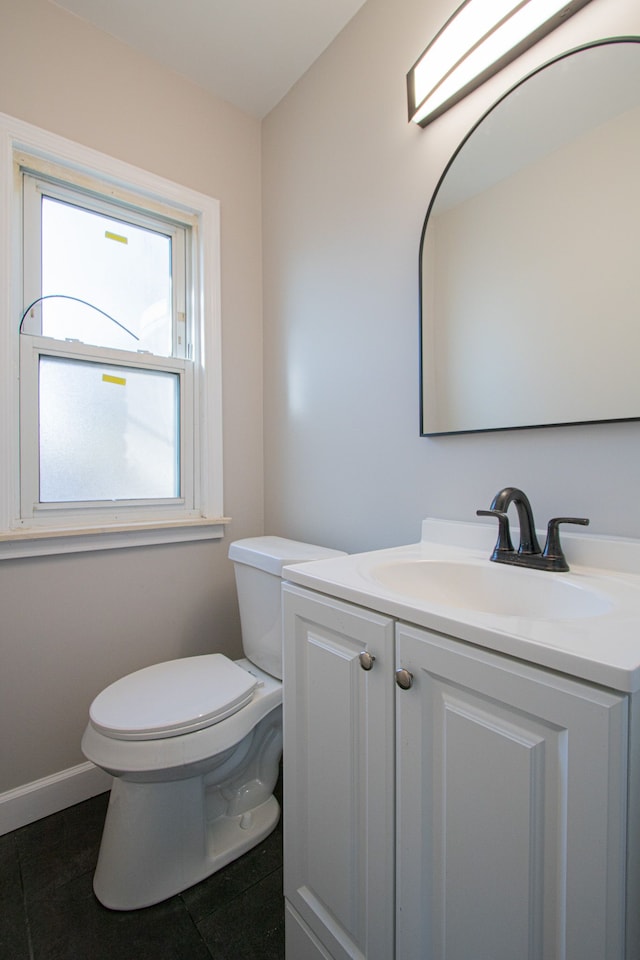 bathroom featuring tile patterned flooring, vanity, and toilet