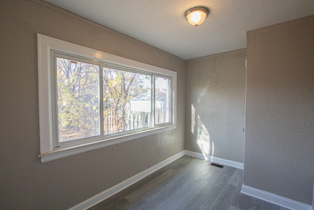 unfurnished room featuring dark hardwood / wood-style flooring