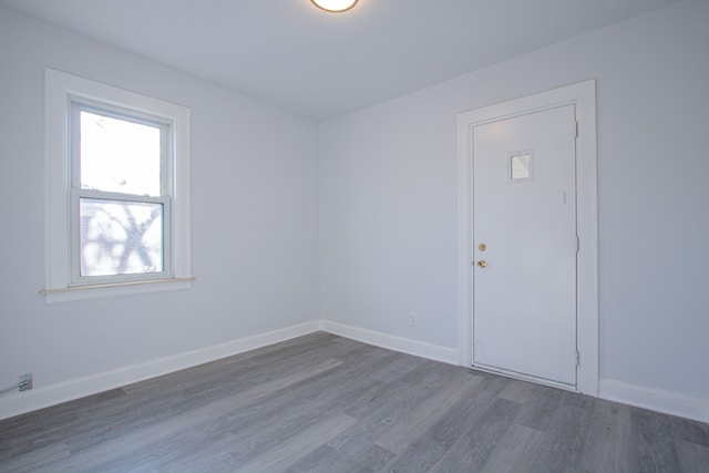 empty room with dark hardwood / wood-style floors