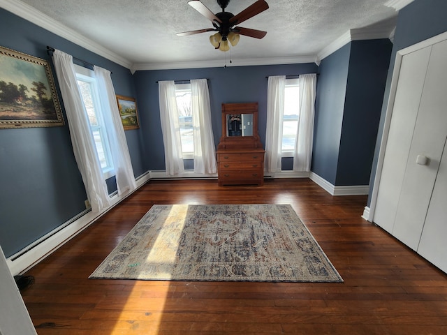 entrance foyer featuring a textured ceiling, plenty of natural light, and dark wood-type flooring