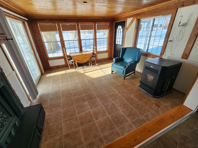 living area featuring a wood stove and wood ceiling