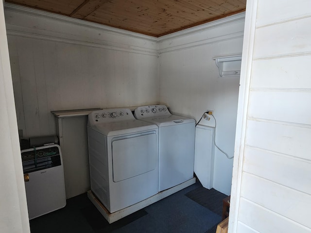 laundry room featuring separate washer and dryer, wood walls, wood ceiling, and ornamental molding