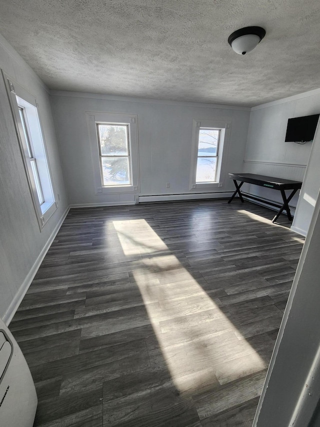 spare room featuring a wealth of natural light and dark wood-type flooring