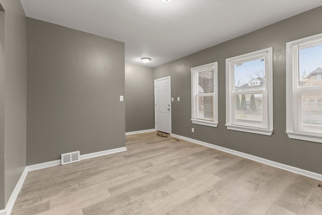 unfurnished room featuring light hardwood / wood-style floors