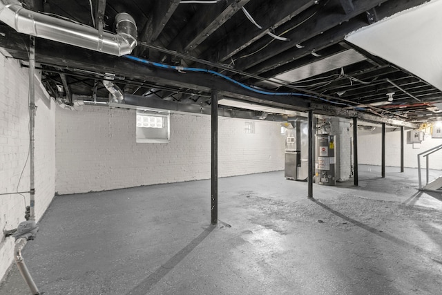 basement with electric panel, heating unit, and water heater