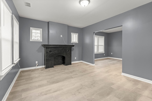 unfurnished living room with light hardwood / wood-style floors and plenty of natural light