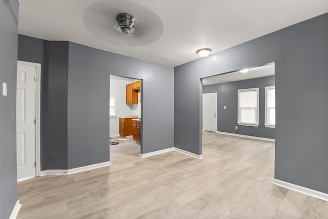 spare room with light hardwood / wood-style floors and ceiling fan