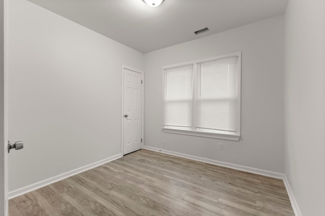 unfurnished room with light hardwood / wood-style flooring