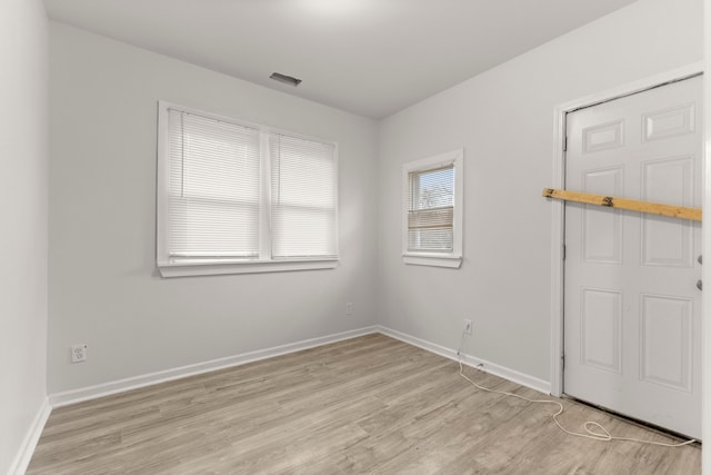 unfurnished room with light hardwood / wood-style flooring