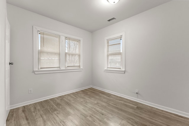 spare room with light wood-type flooring