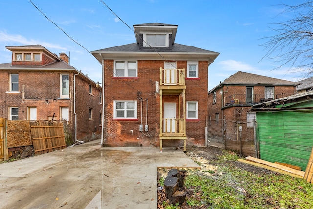 back of property with a balcony