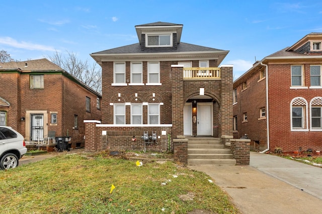 view of front of property featuring a balcony and a front lawn