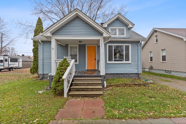 bungalow-style home featuring a front yard