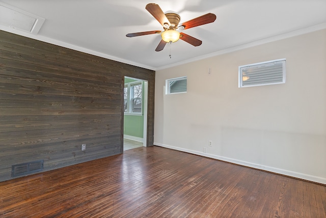 unfurnished room with crown molding, ceiling fan, and dark wood-type flooring