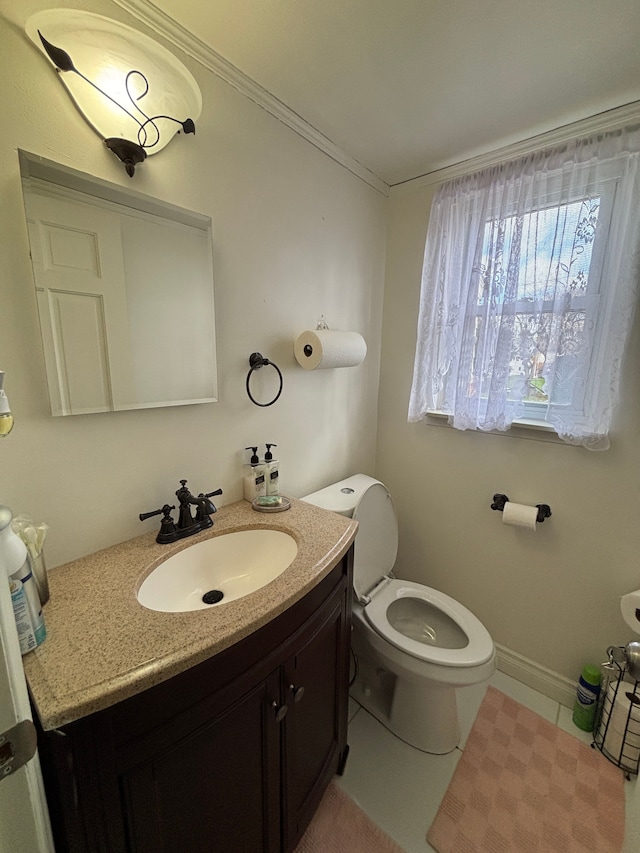 bathroom with tile patterned floors, vanity, toilet, and crown molding