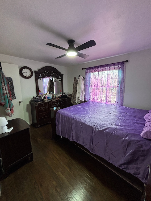 bedroom with ceiling fan and dark wood-type flooring