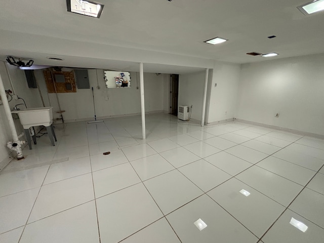 basement featuring light tile patterned floors and electric panel