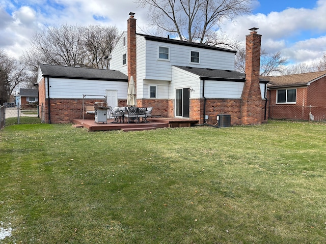 back of property featuring central AC, a wooden deck, and a lawn