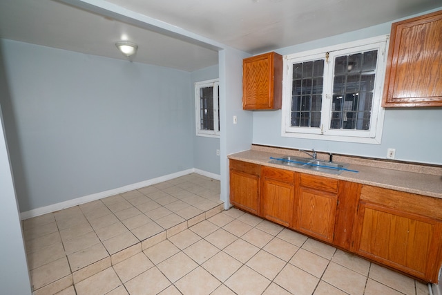 kitchen featuring light tile patterned flooring and sink