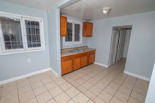 kitchen featuring light tile patterned flooring and sink