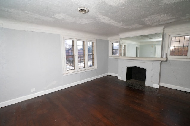 unfurnished living room featuring hardwood / wood-style floors and a textured ceiling