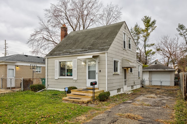 view of front of property with a front lawn, an outdoor structure, and a garage