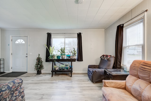 living room featuring light hardwood / wood-style floors and ornamental molding