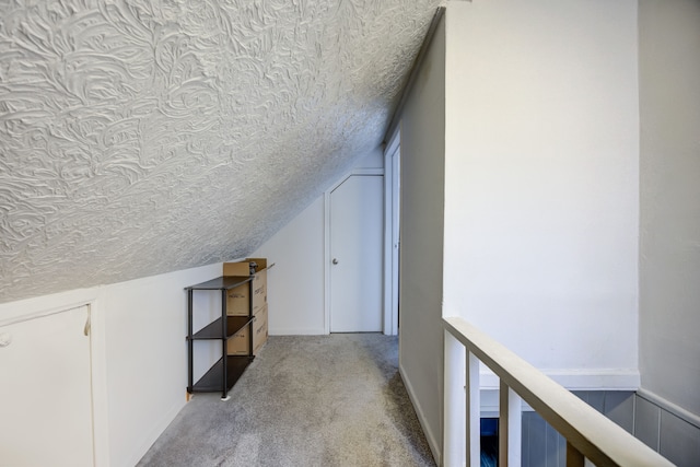 additional living space featuring a textured ceiling, light colored carpet, and lofted ceiling