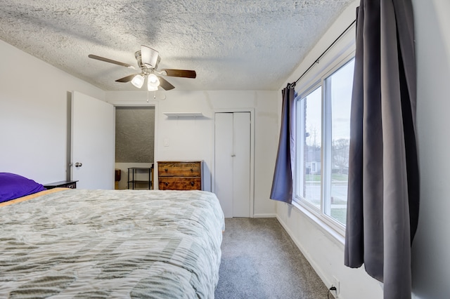 bedroom with carpet, ceiling fan, a textured ceiling, and a closet