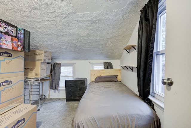 bedroom with carpet and a textured ceiling