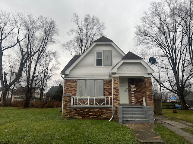 bungalow-style house featuring a front yard